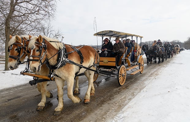 Members and missionaries ride wagons down Main and Parley Streets in Nauvoo to commemorate the 1846 Nauvoo Exodus. Photo courtesy of Bruce Cornwell.
